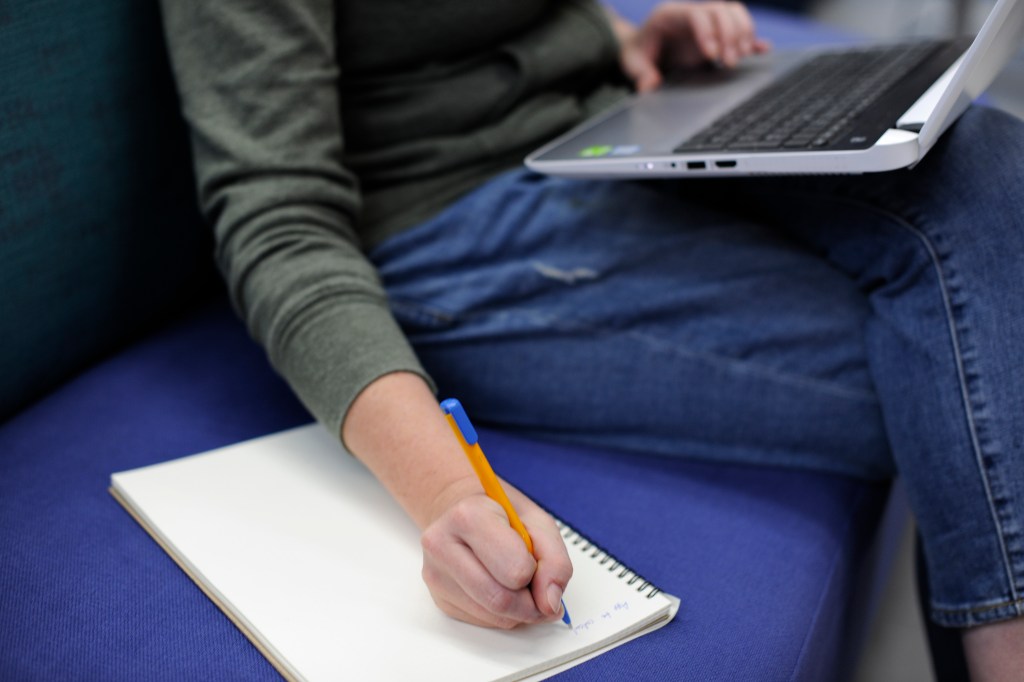 Startup Business People Writing on Notebook